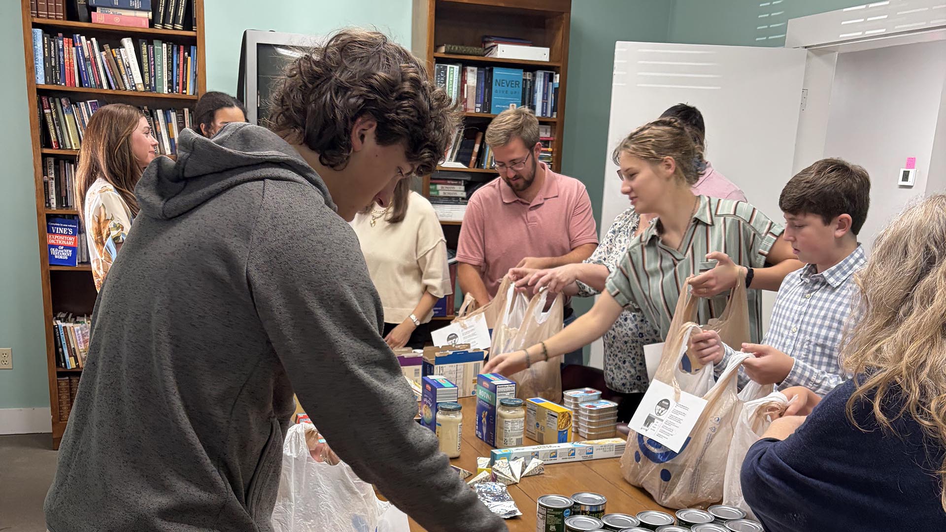 Church members packing bags of food for outreach
